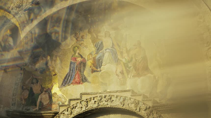 The bird flies by the artwork over the arch