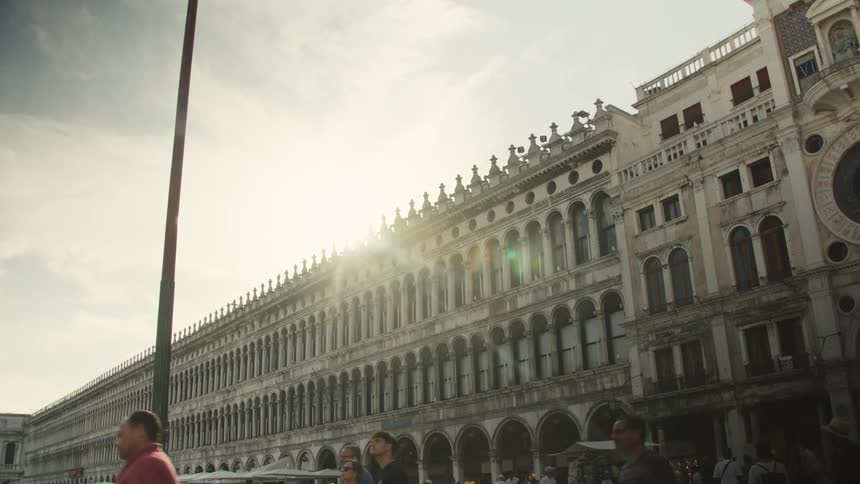 People cross over to the long building