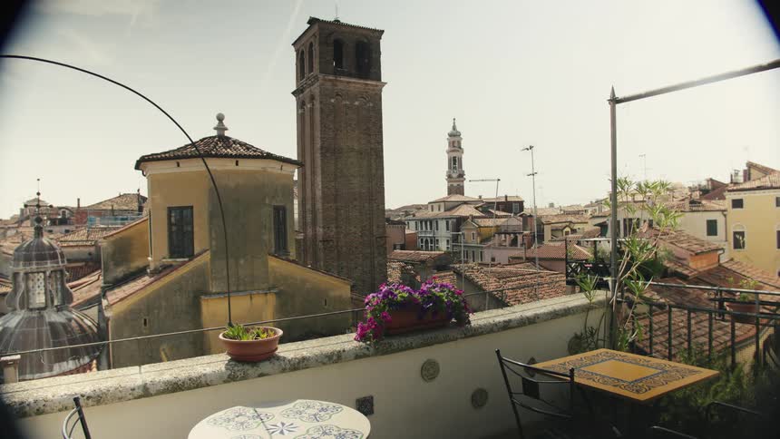 Rooftops of old buildings on a small city seen from a balcony outdoors during day time