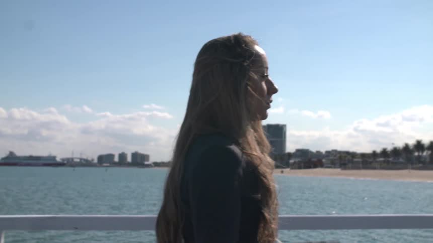 Woman walks along the pier