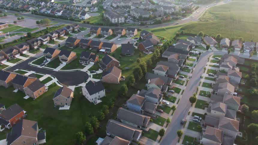 Suburban houses arranged in symmetrical streets seen from above