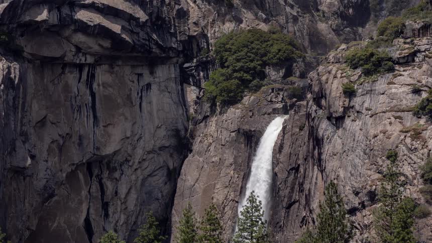 The waterfall is rushing on the mountain