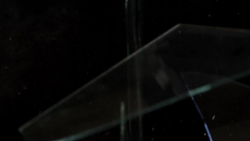 Closeup of broken glass shards against a black background
