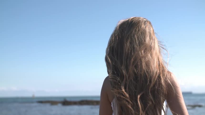 Woman walks on a beach