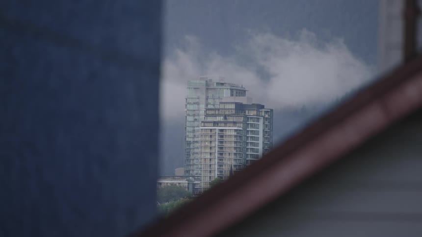 A tall apartment building is in the distance