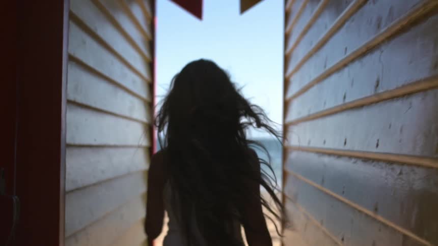 Woman running between two homes