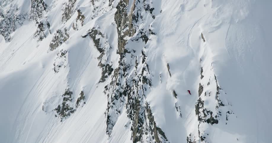 The person snowboarding causes an avalanche