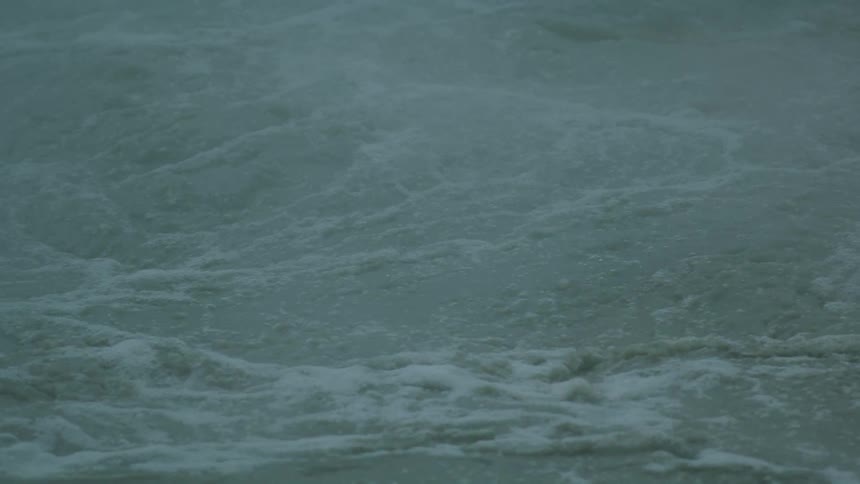 Turbulent water surface with grayish foam
