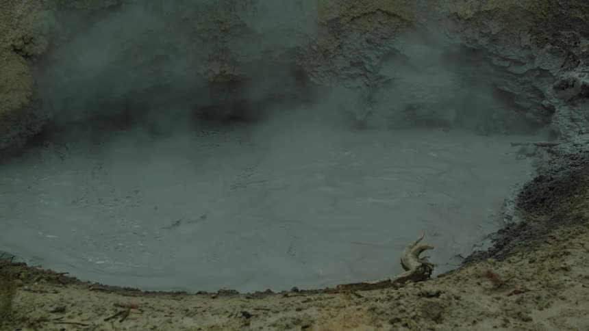 Steam rises from the hot spring