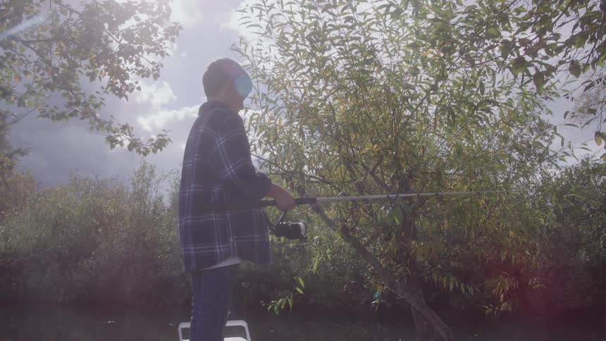 The child is fishing in the creek