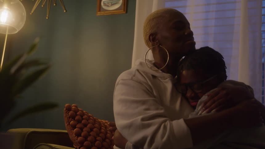 Mother hugs her son tenderly in a quiet moment of comfort