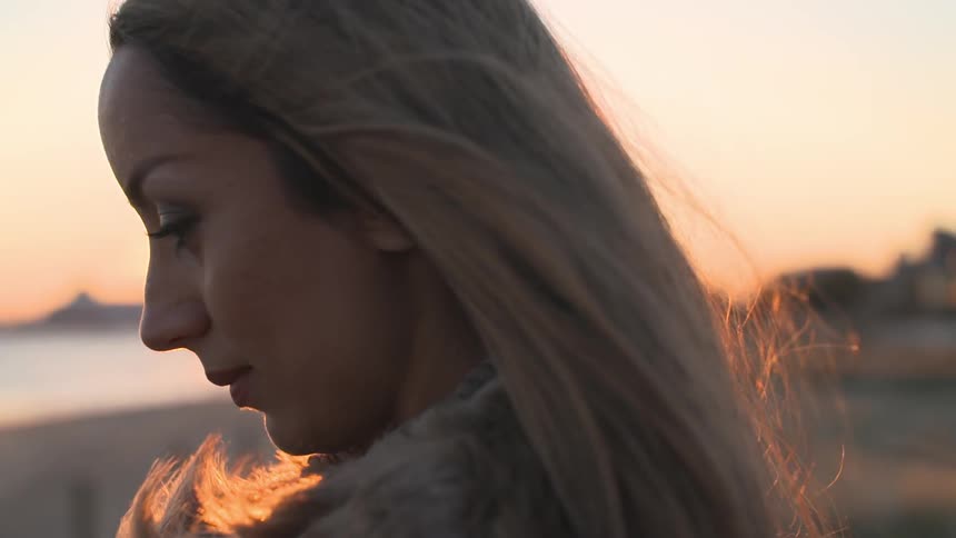 A woman outside at sunset