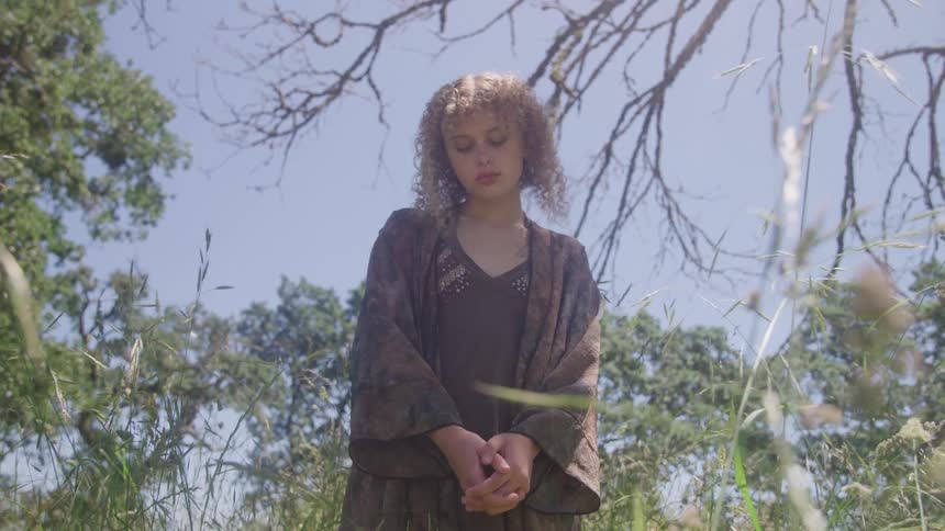 A woman standing in a field