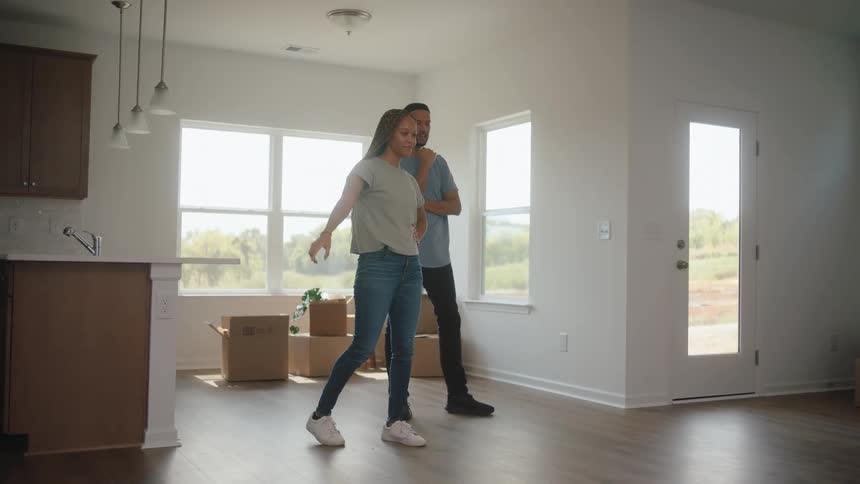 A couple standing in an empty room