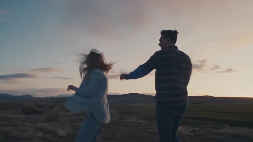 The man and woman dance together on the field