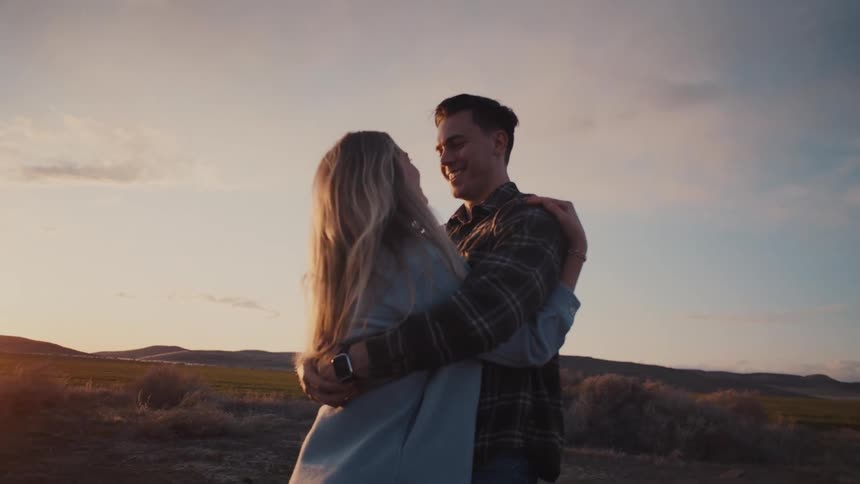 A couple hugging in the sunset