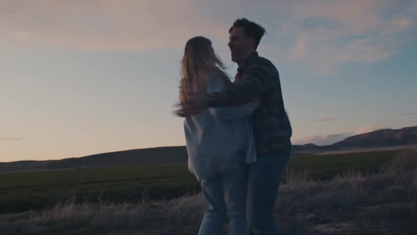 The couple have fun dancing on the field