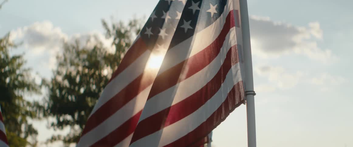 The wind blows the flag on a sunny day