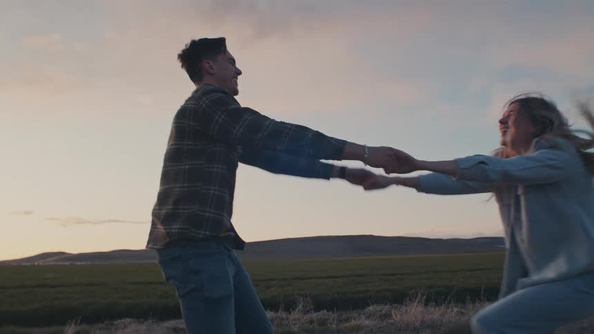 A couple dancing in a field