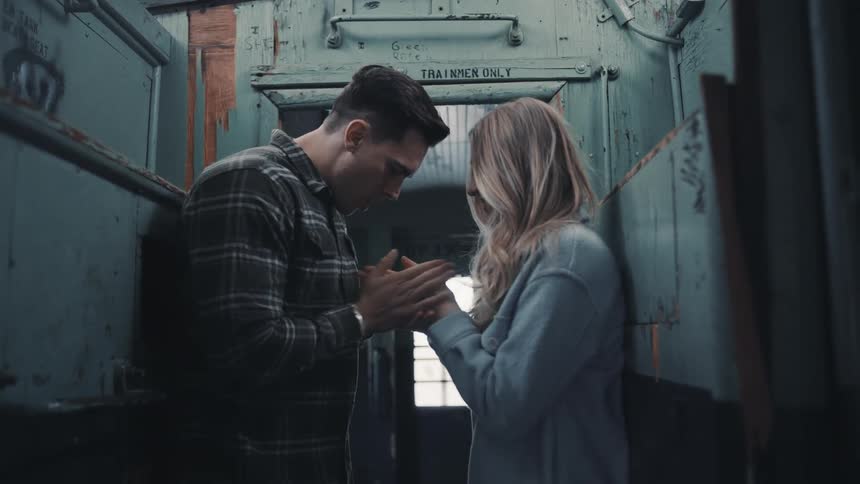 The man rubs and warms a womans hands