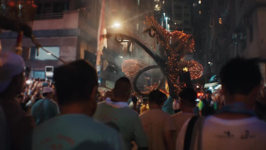 Night procession celebrates tradition with a dragon illuminated by sparks