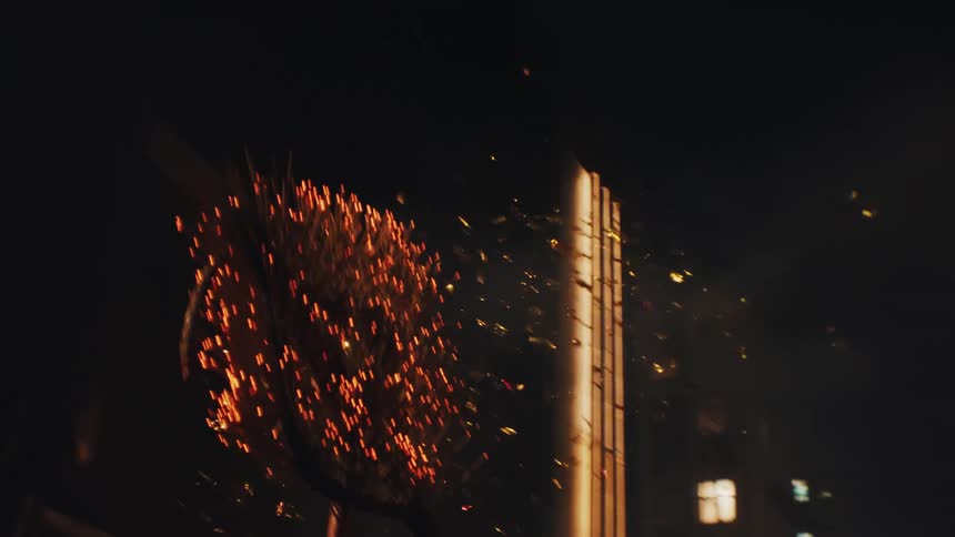 Sparks fly as the fire dragon lights up the urban night