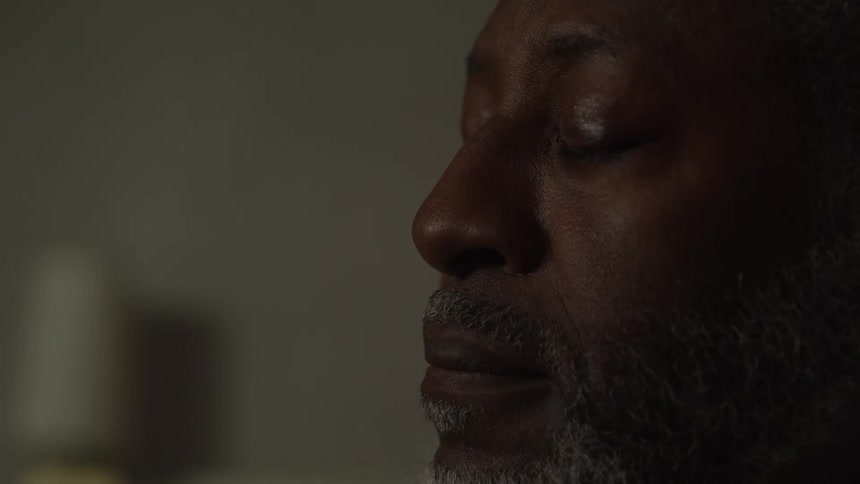 Person with closed eyes in a closeup featuring a calm expression and soft lighting highlighting the face