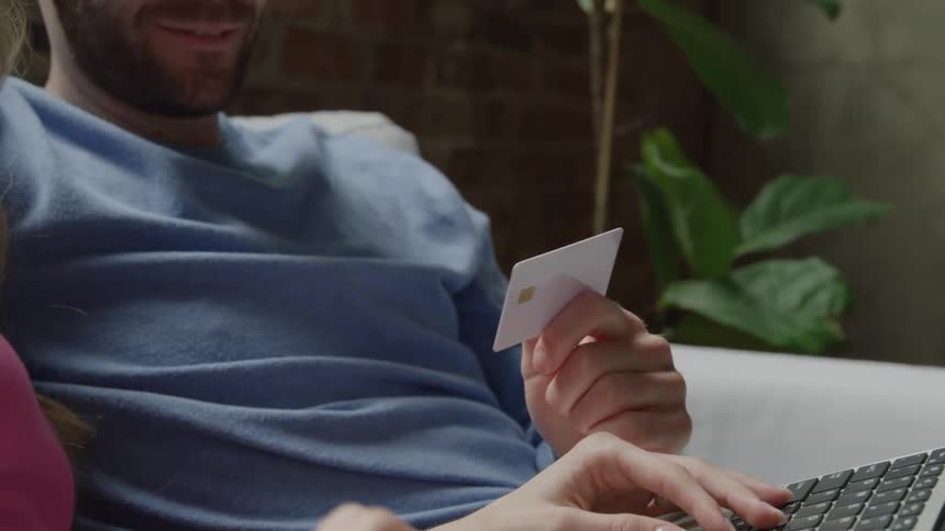 Man holding a card with a smiling woman beside him