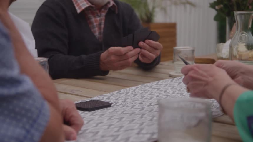 People sitting at a table playing cards