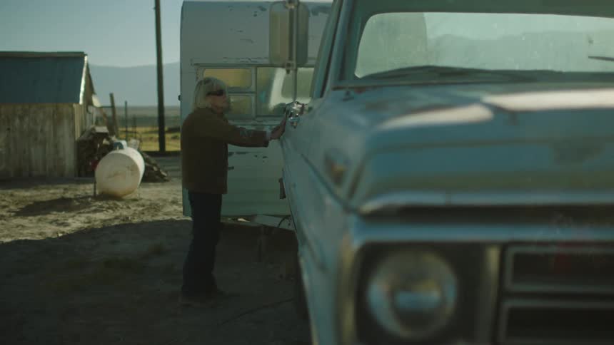 Blind woman walks over to truck and feels it with her hands