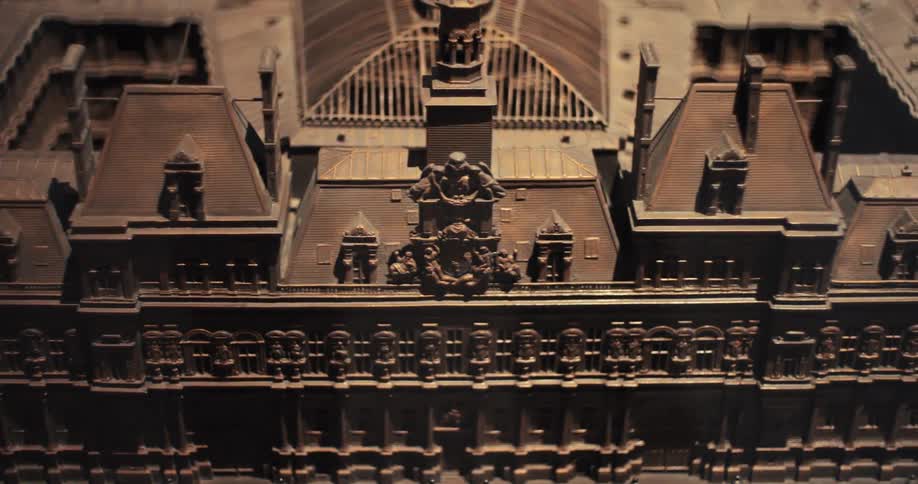 An architectural model of a building structure is on display showcasing detailed design elements and structural layout in a compact scaled format