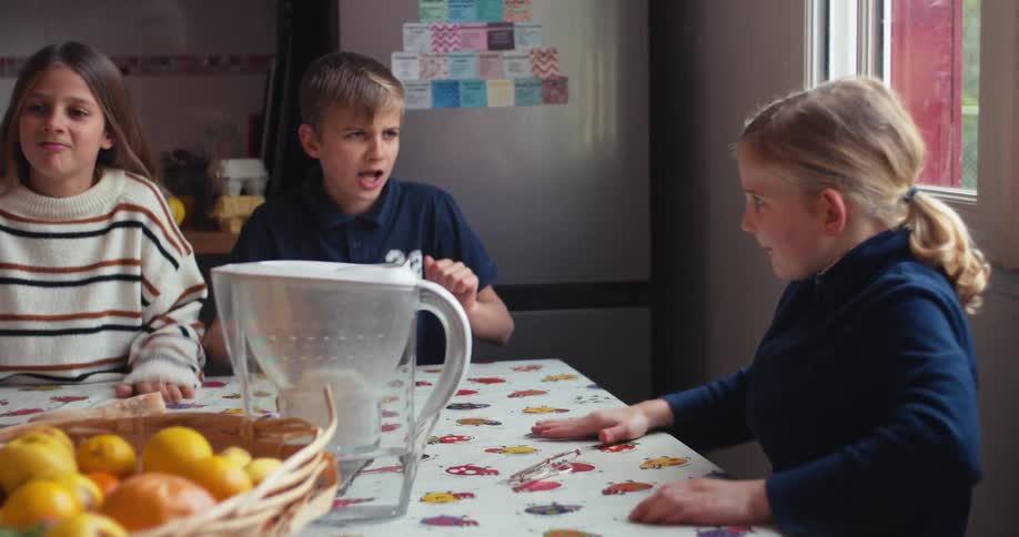 Kids are playing at the kitchen table while waiting for breakfast