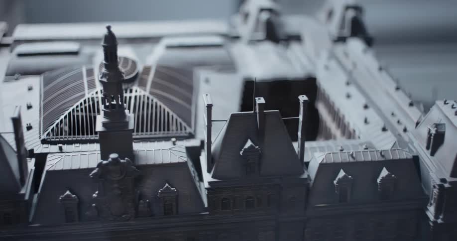 Detailed miniature of a historic building with a lit central tower