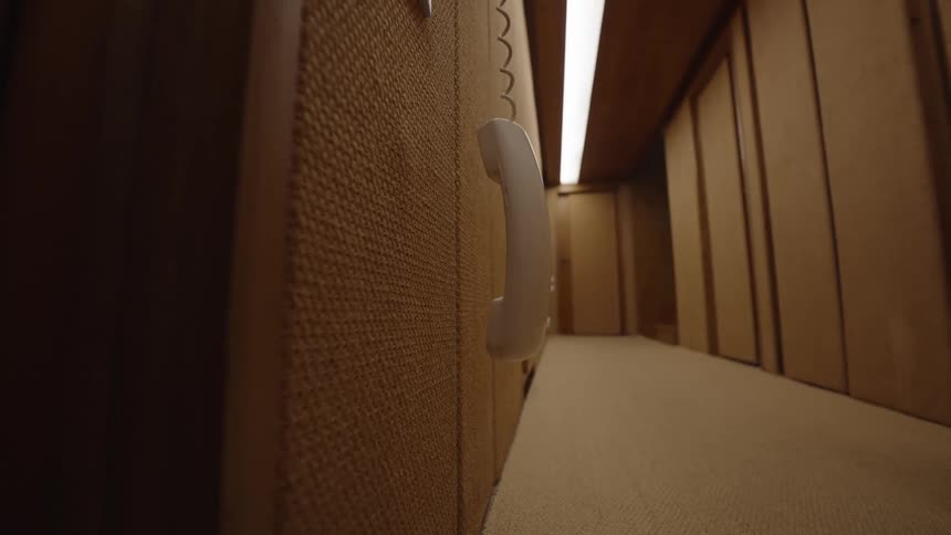 The phone hangs from a cord in the hall