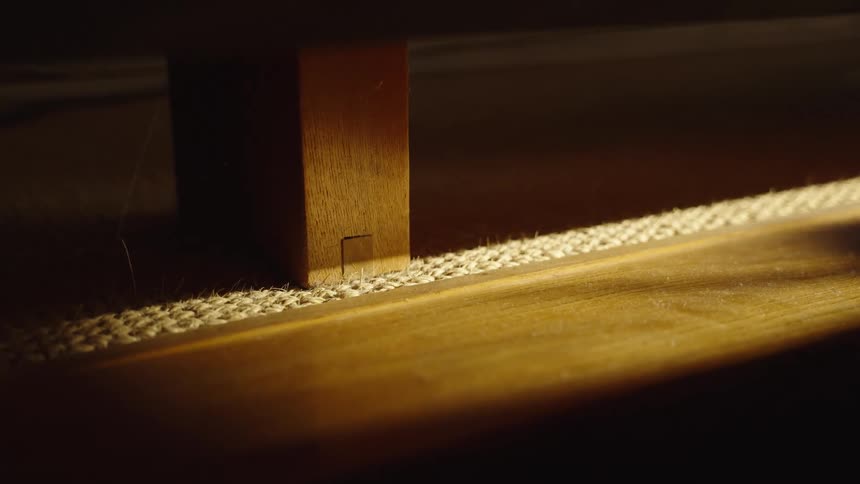 Close up of a wooden furniture leg indoors during daytime