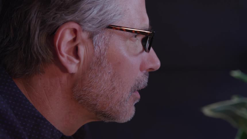 Man attentively observes something in front of him