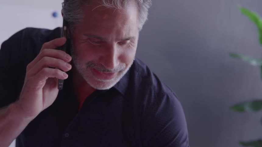 Man talks on the phone while working in the office