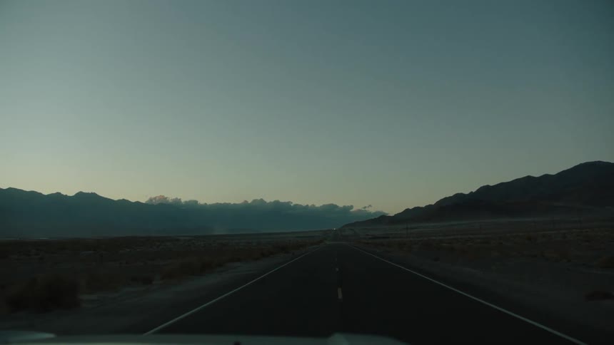 Car traveling on a highway after sunset