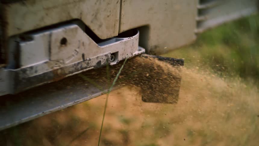 Close up of a agricultural machinery in use on a field outdoors during daytime