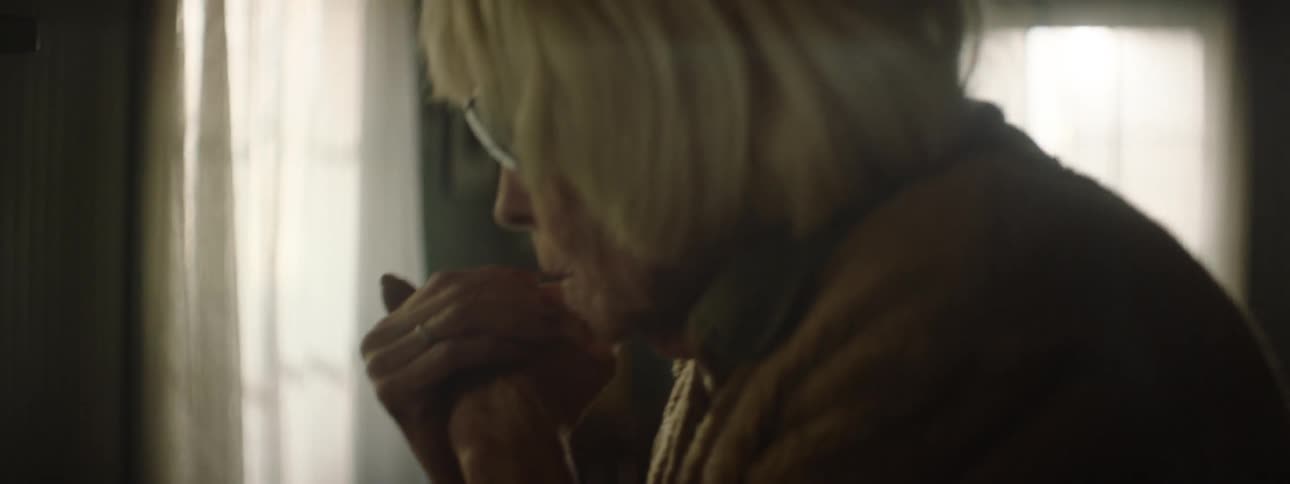 A woman with sunglasses in a house worrying