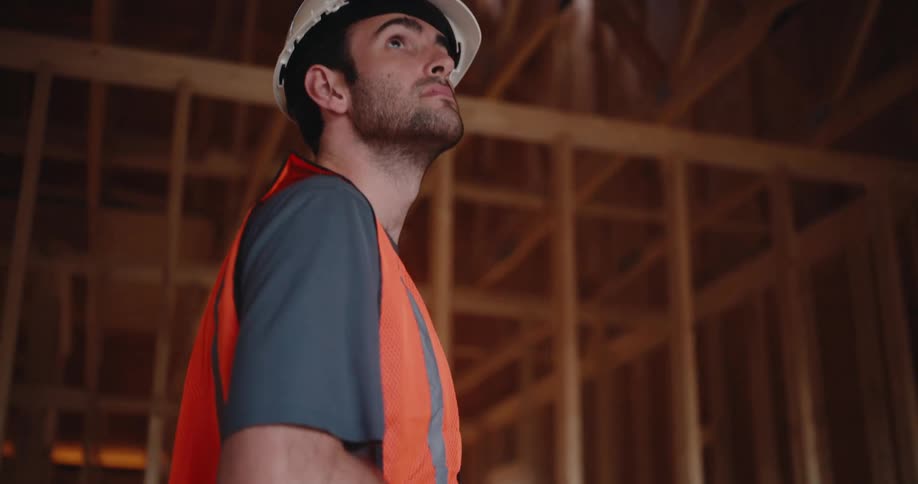 A carpenter inspects a room