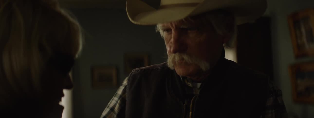 A man tries to look at an older woman's hand