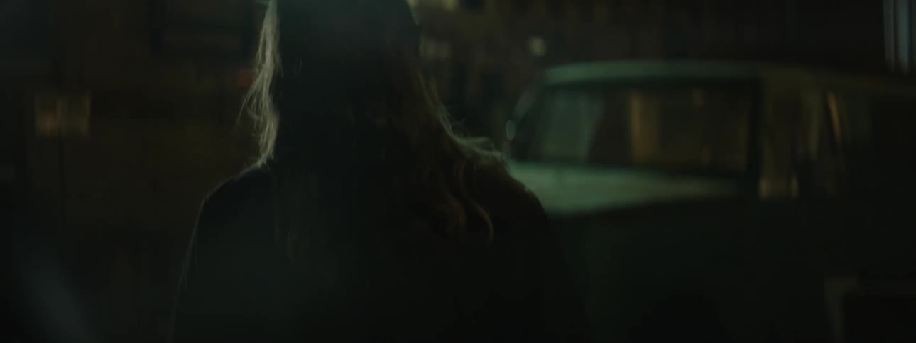 A man looks around at some blinking lights above