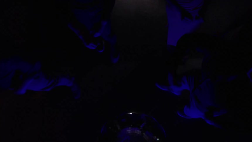 People are dancing under the disco ball