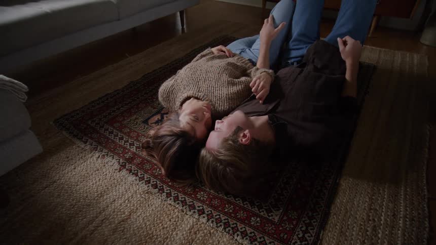 A man and woman lay on the floor together