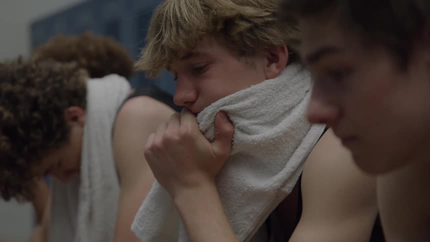 Players sit exhausted in the locker room after an intense game