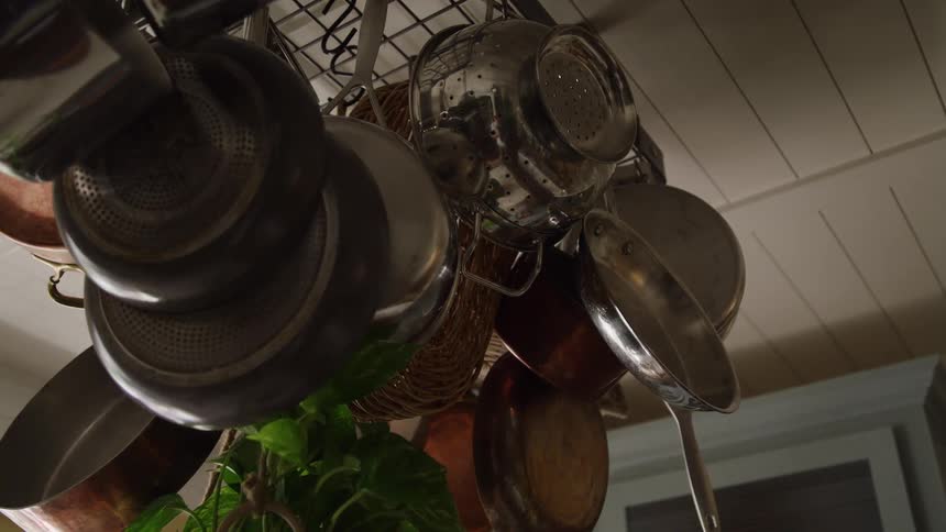 Pots and utensils hanging above a kitchen counter