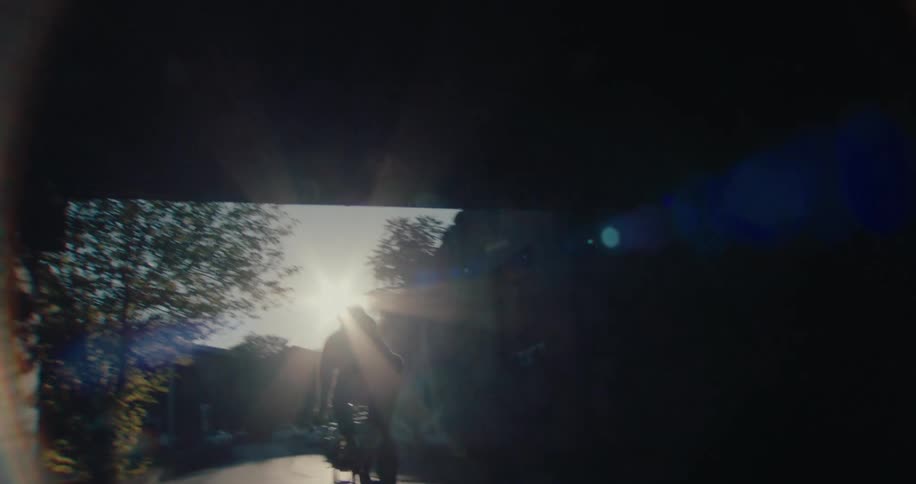 A person rides their bike out onto the street