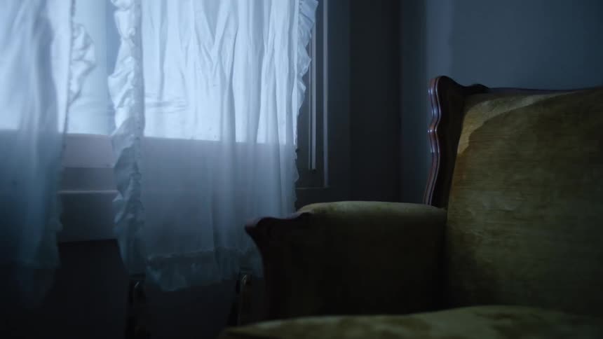 Lights shine into a living room window