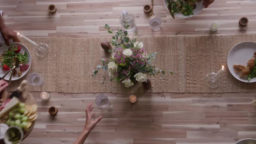 Friends clear the food from a table
